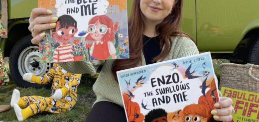 Charlotte is holding up Omar, the bees and Me children's book and new book Enzo, the Swallows and Me children's book